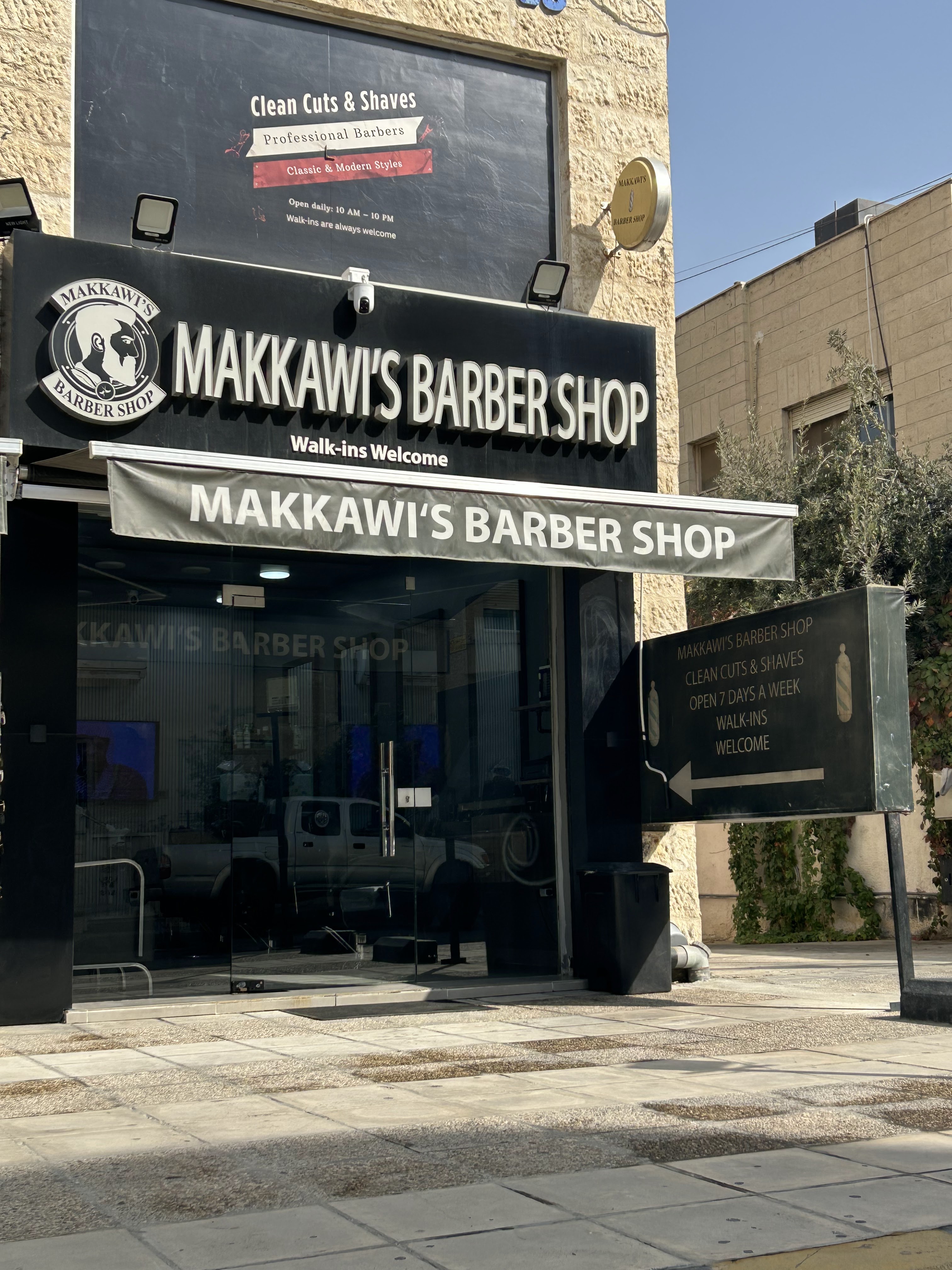 Makkawi's Barber Shop storefront with its circular logo sign