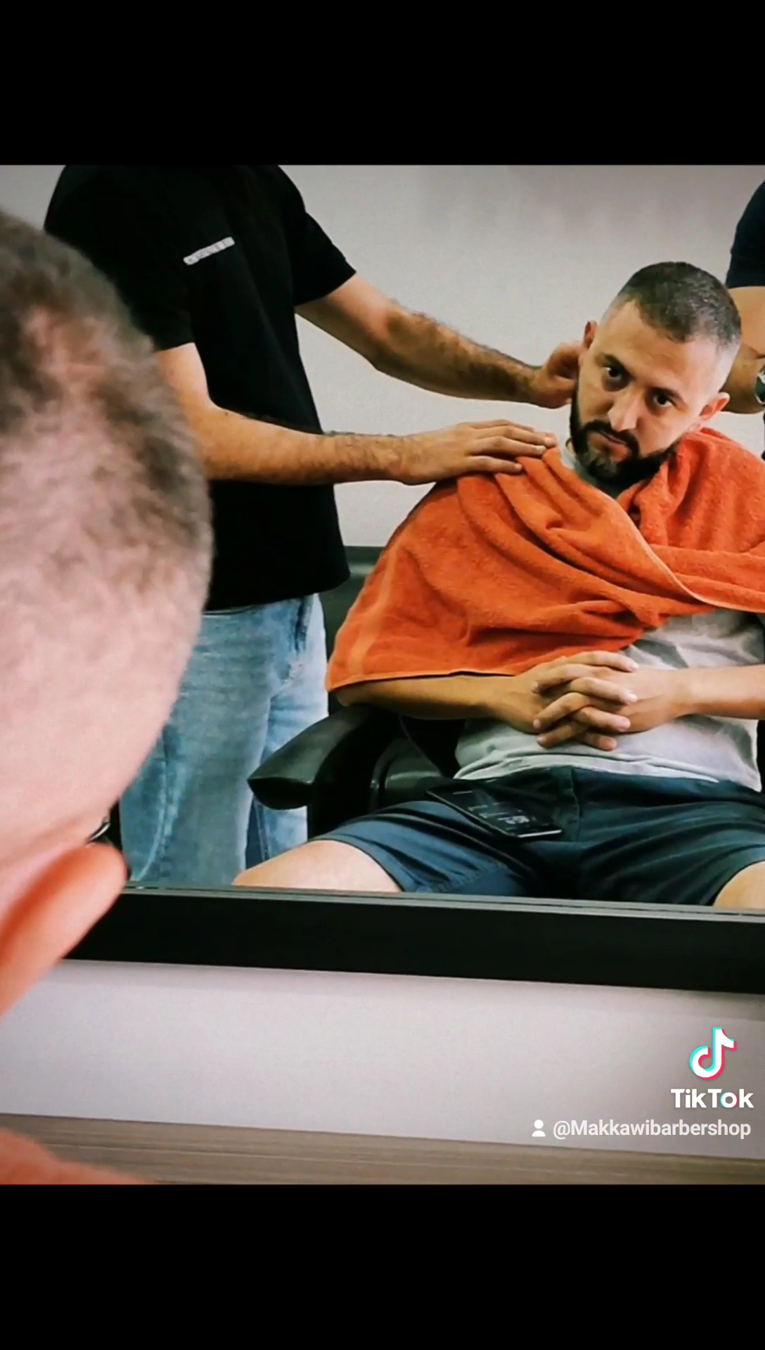 Client wrapped in a hot towel after a shave at Makkawi's